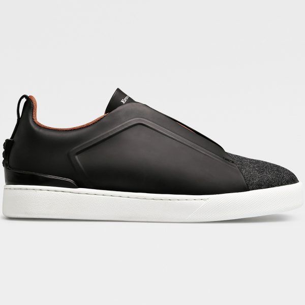 From Ermenegildo Zegna’s Couture collection, the Triple Stitched low-top sneaker is constructed of dark navy matte leather and gray flannel, and is lined with breathable mesh and smooth leather.