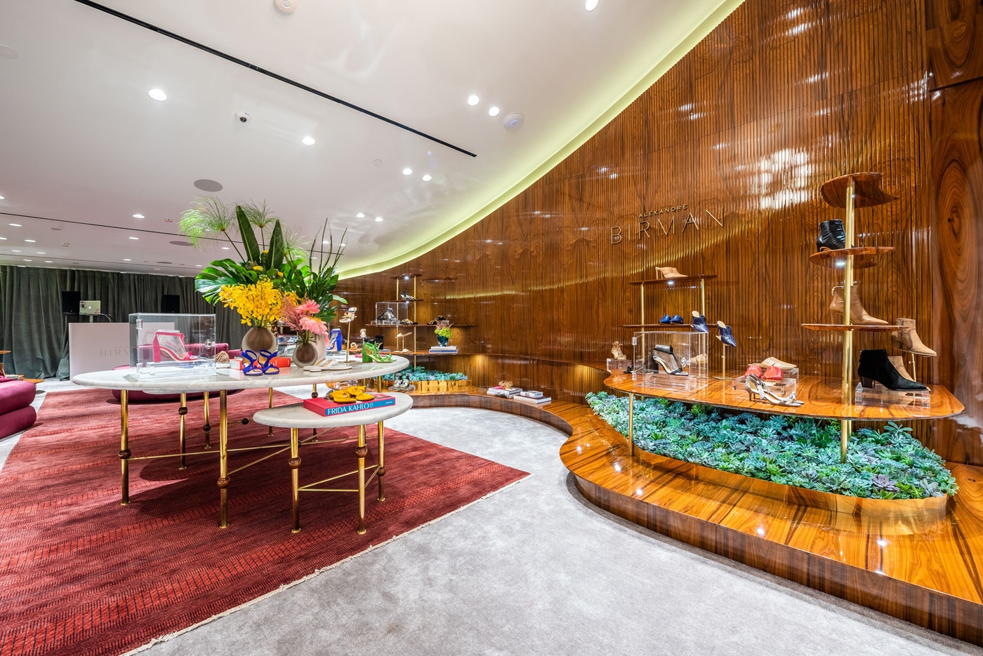 Inside the newly opened Alexandre Birman Bal Harbour boutique inspired by Brazilian mid-century design, which can be seen by the architectural chandeliers and ridge design along the walls.