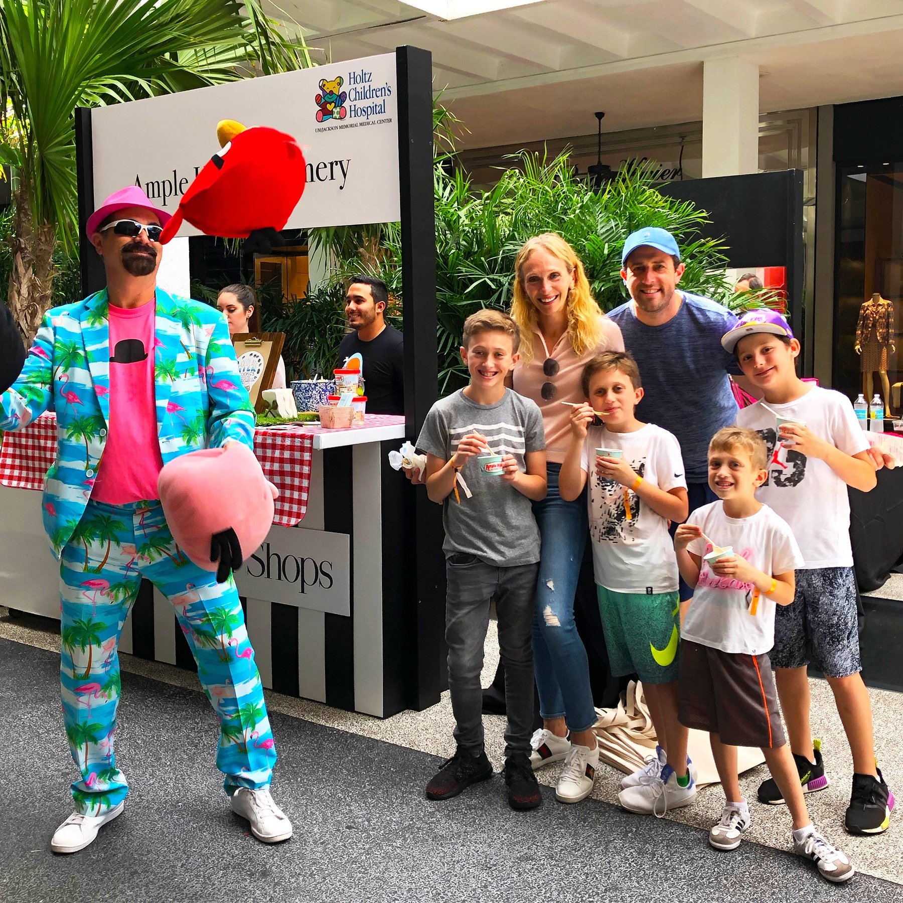 Family enjoys eating Ample Hills Creamery ice cream while being entertained by juggler at Ice Cream We Love 2019