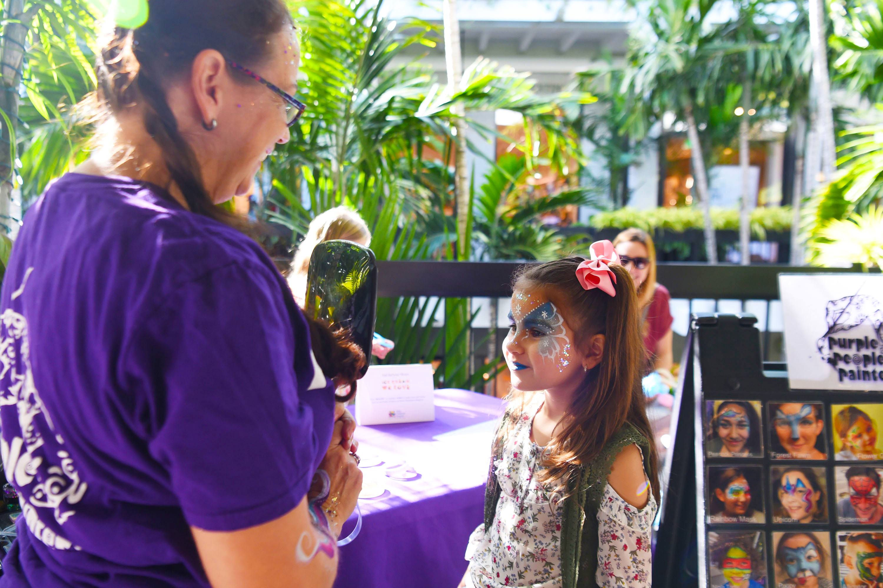 Kids enjoyed getting their faces painted on Level 2 of the Shops
