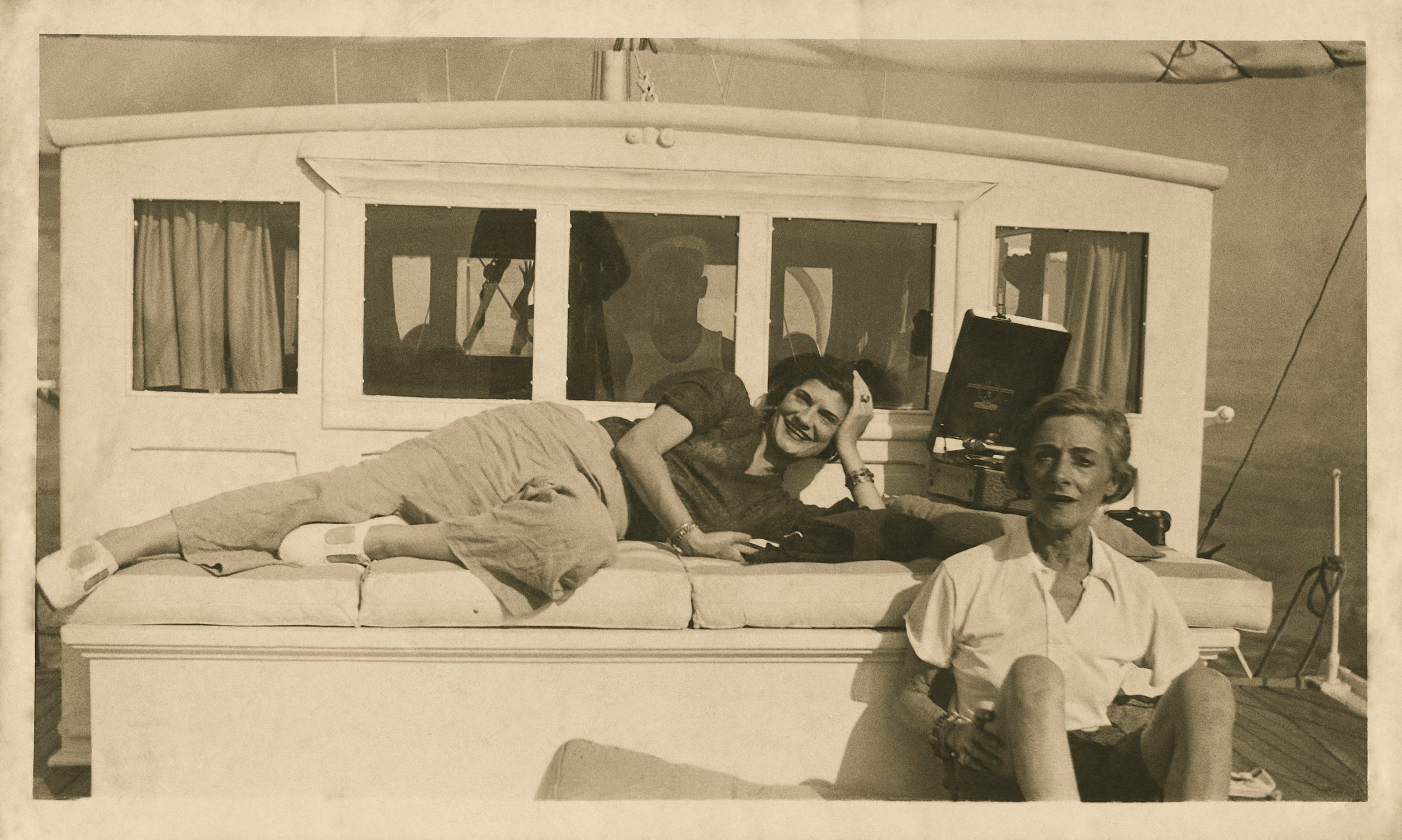 Black and White photograph of Gabrielle Chanel and Roussey Sert enjoying themselves on a boat circa 1935