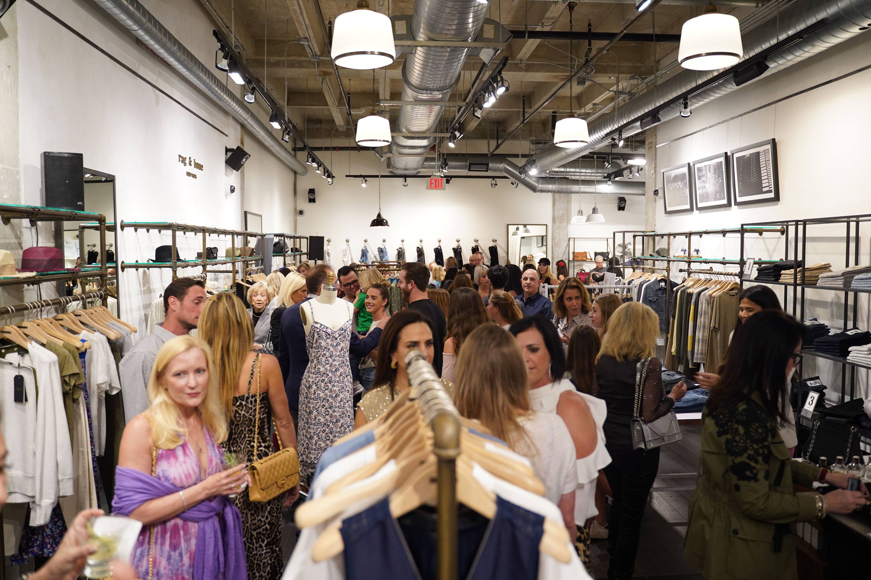 Ambiance image of guests at Rag & Bone Bal Harbour enjoying the fundraiser for The Childhood Cancer Project
