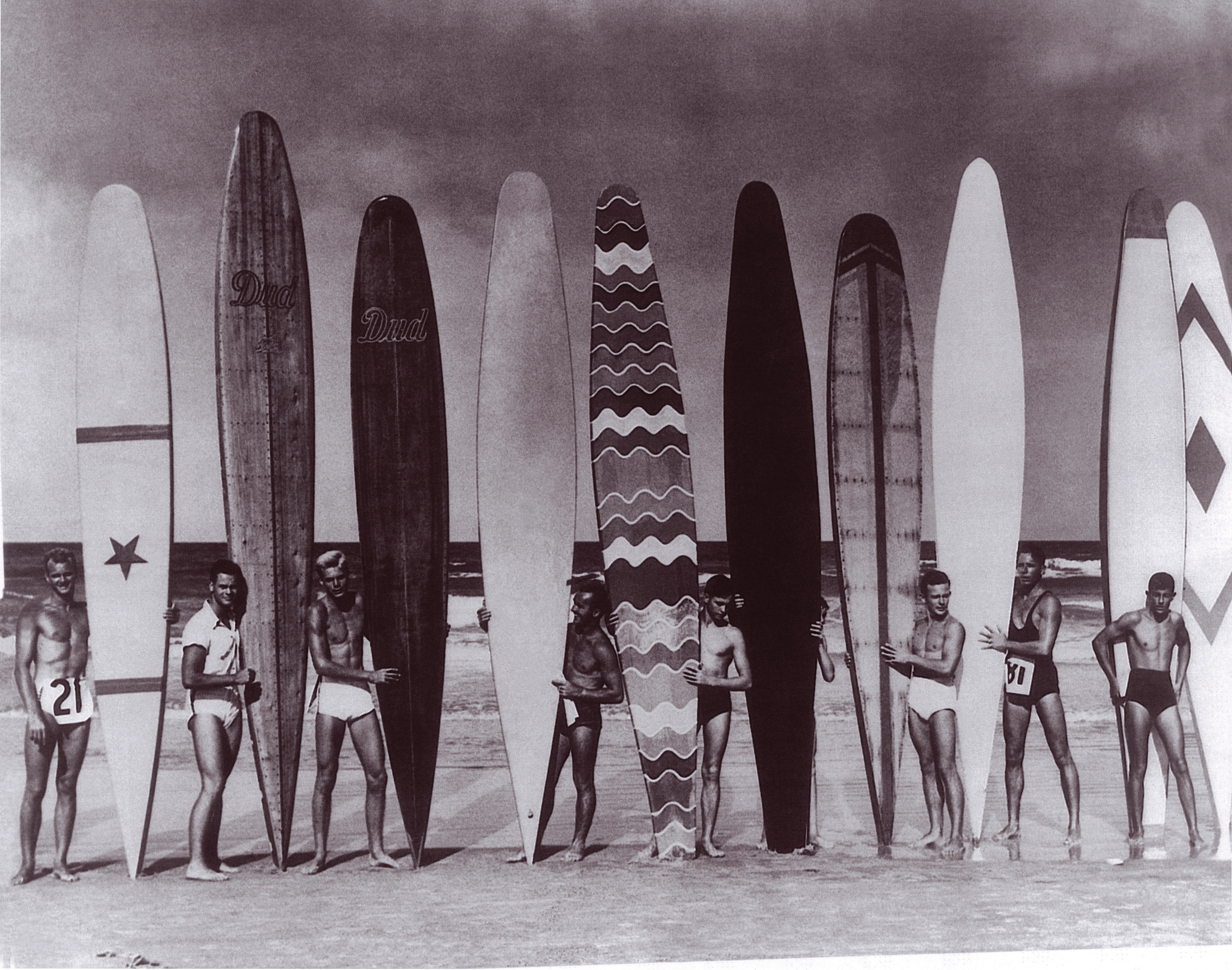 Black and white image of Stanley Whitman and his brothers Bill and Dudley with other surfers at Daytona Beach circa 1934