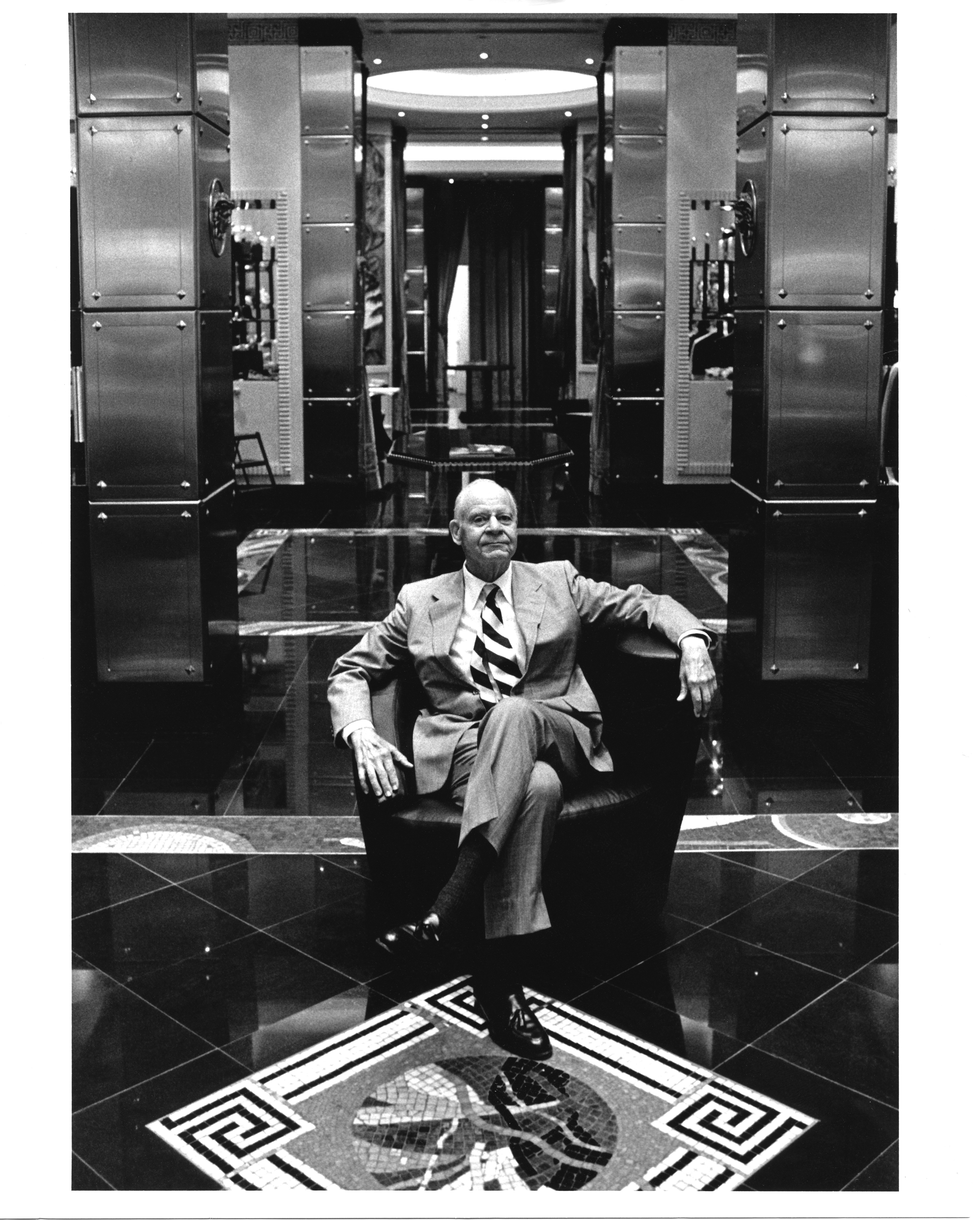 Black and white image of retail visionary and creator of Bal Harbour Shops Stanley Whitman inside Versace Bal Harbour in 1991
