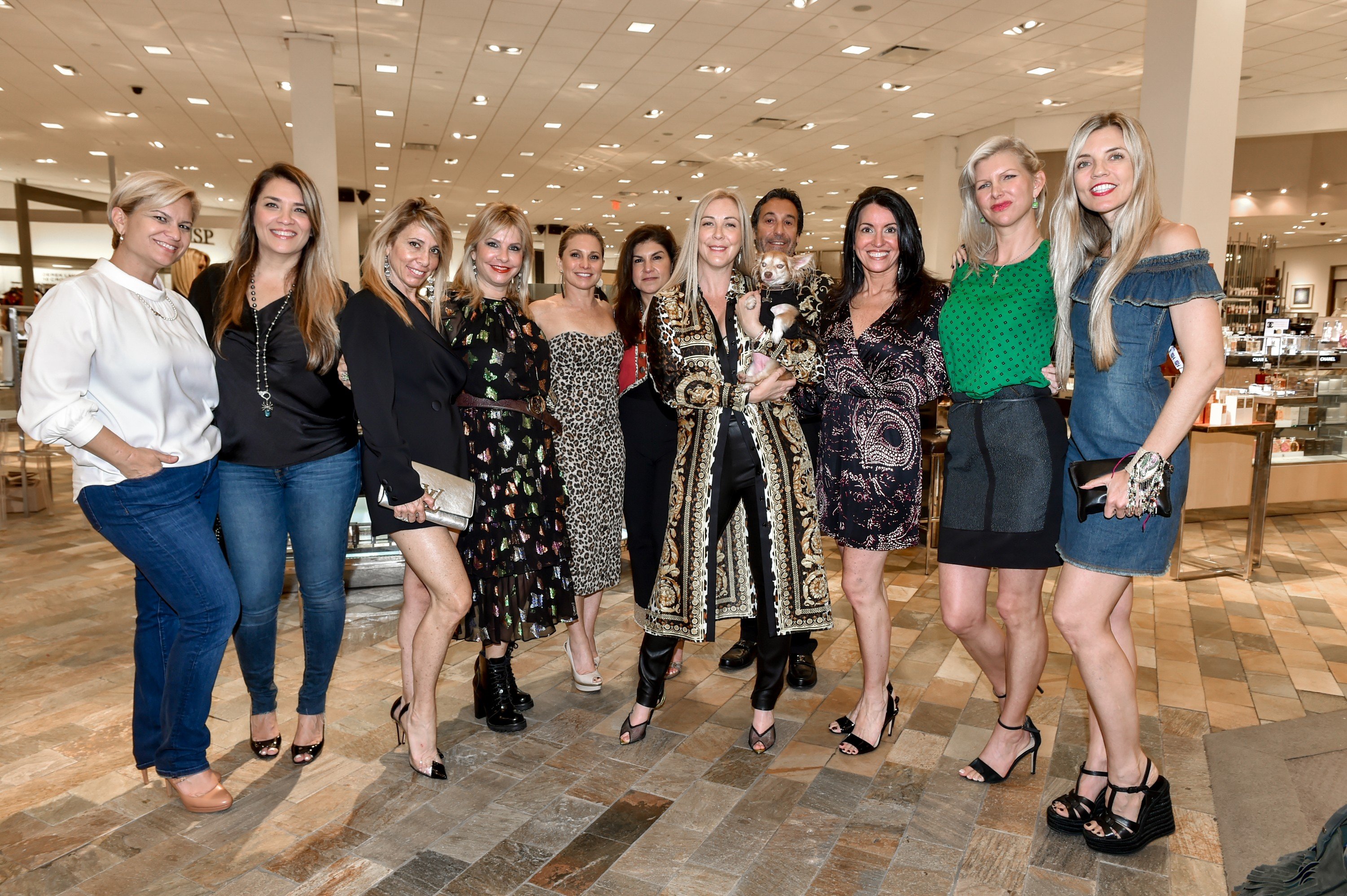 Guests of Walk in Style for the Animals posing for a group photo inside Neiman Marcus Bal Harbour