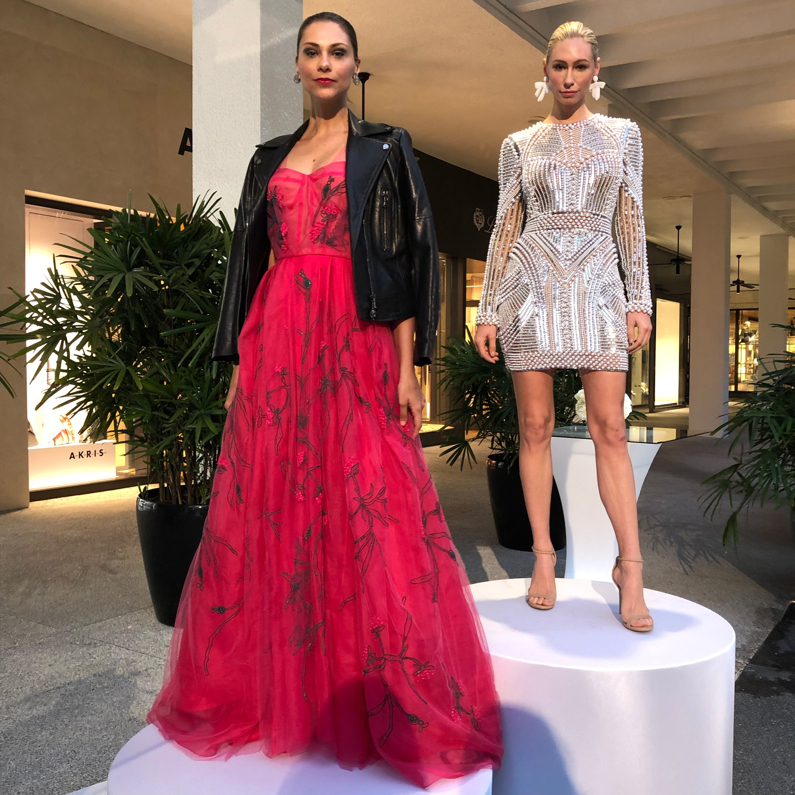 Neiman Marcus models wearing red Carolina Herrera dress and a Balmain sequin cocktail dress