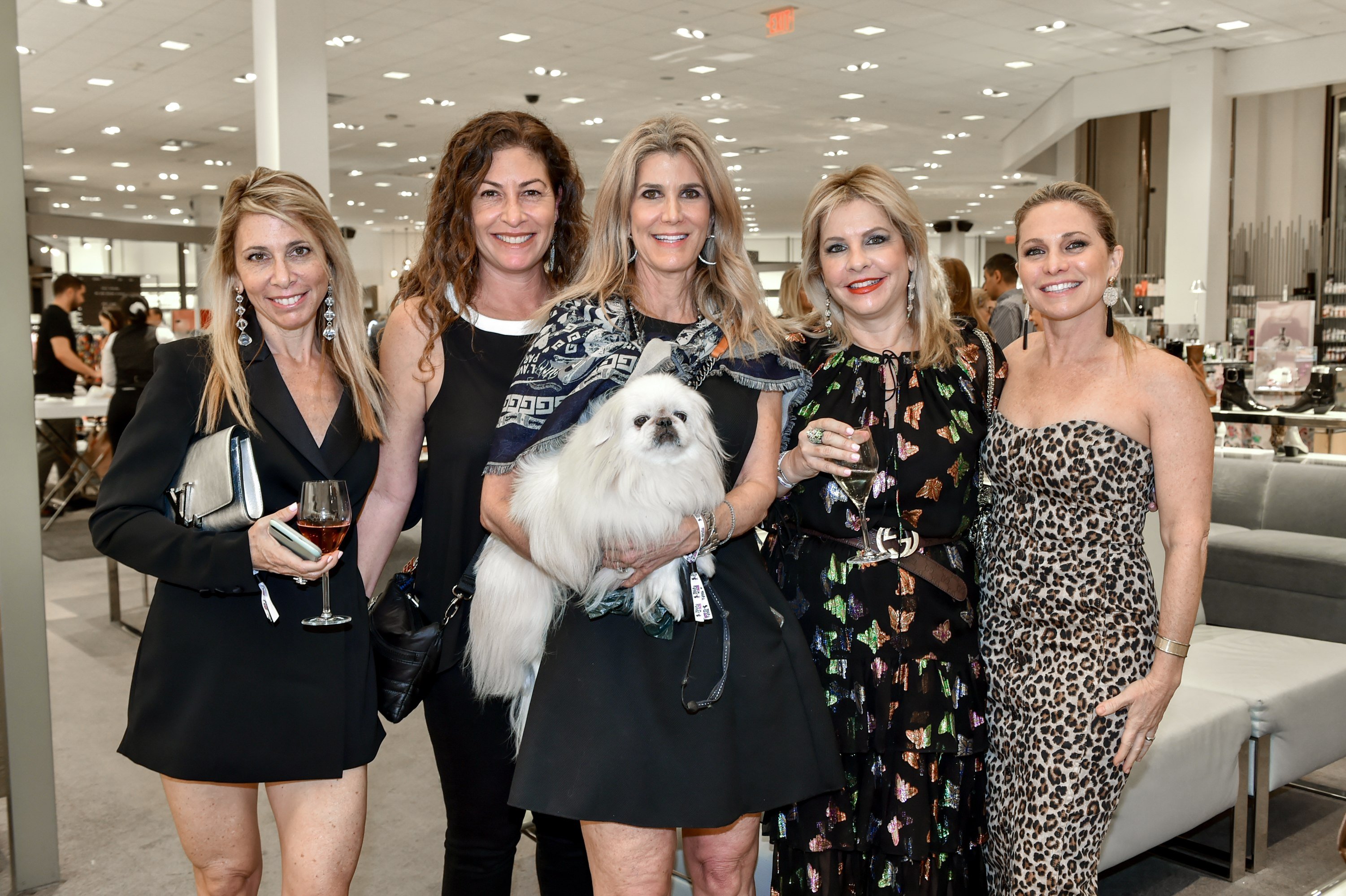 Guests enjoying time with their pooches at the Walk in Style for the Animals event at Neiman Marcus Bal Harbour