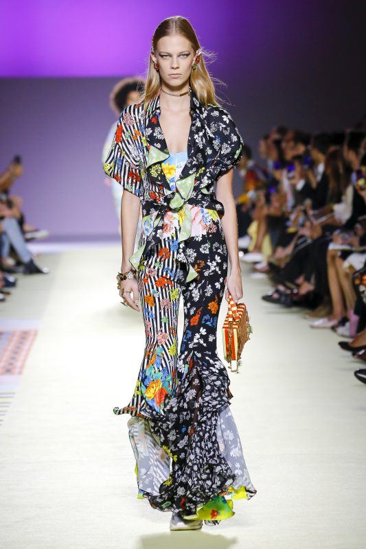 Versace Spring 2019 runway look, wide-leg ruffled bottom bodysuit with v-cut neck in stripes and floral patterns