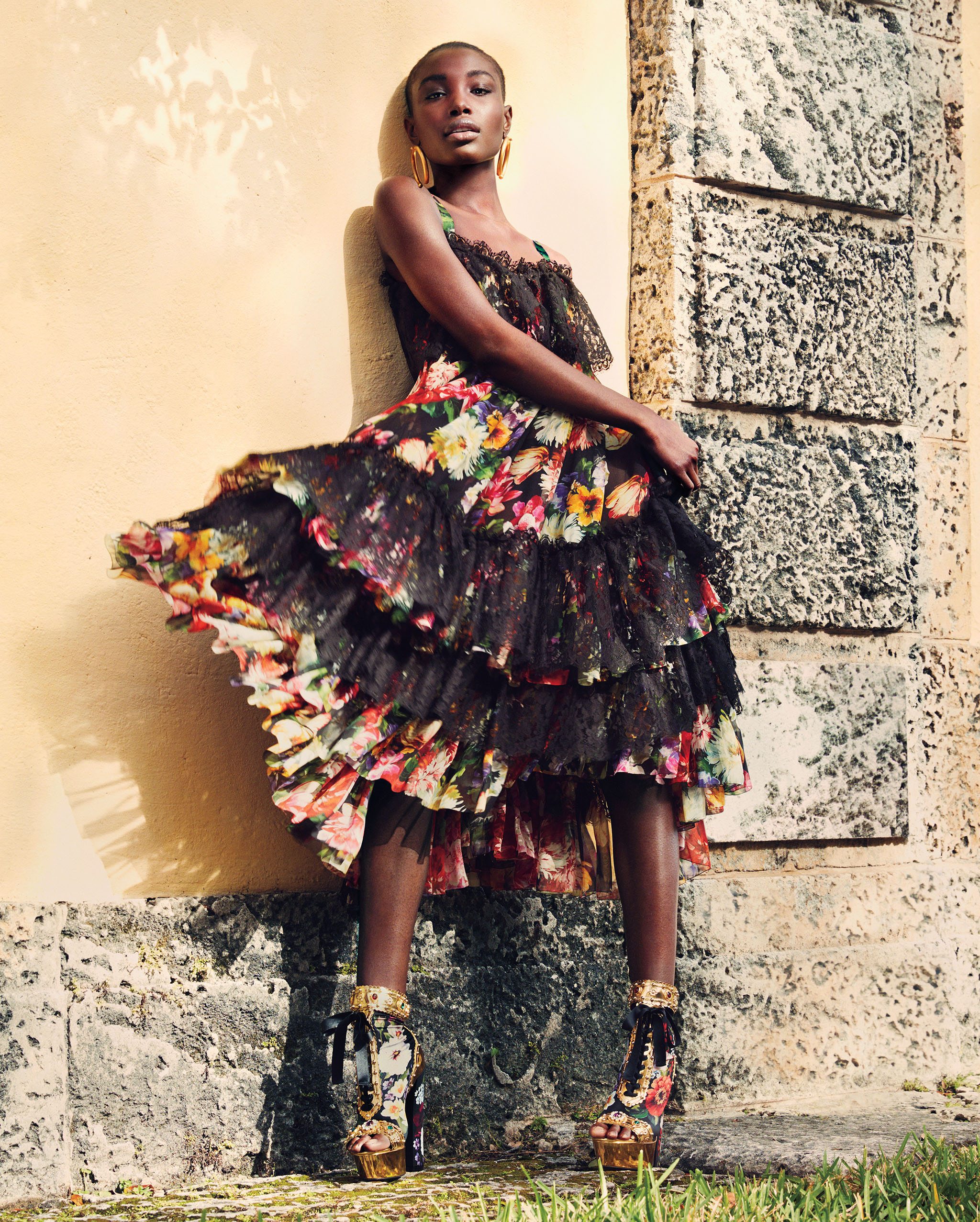 Dolce & Gabbana floral and lace ruffled dress and peep-toe platform boots with gold detailing, 305.866.0503. Valentino earrings, 305.867.1215.