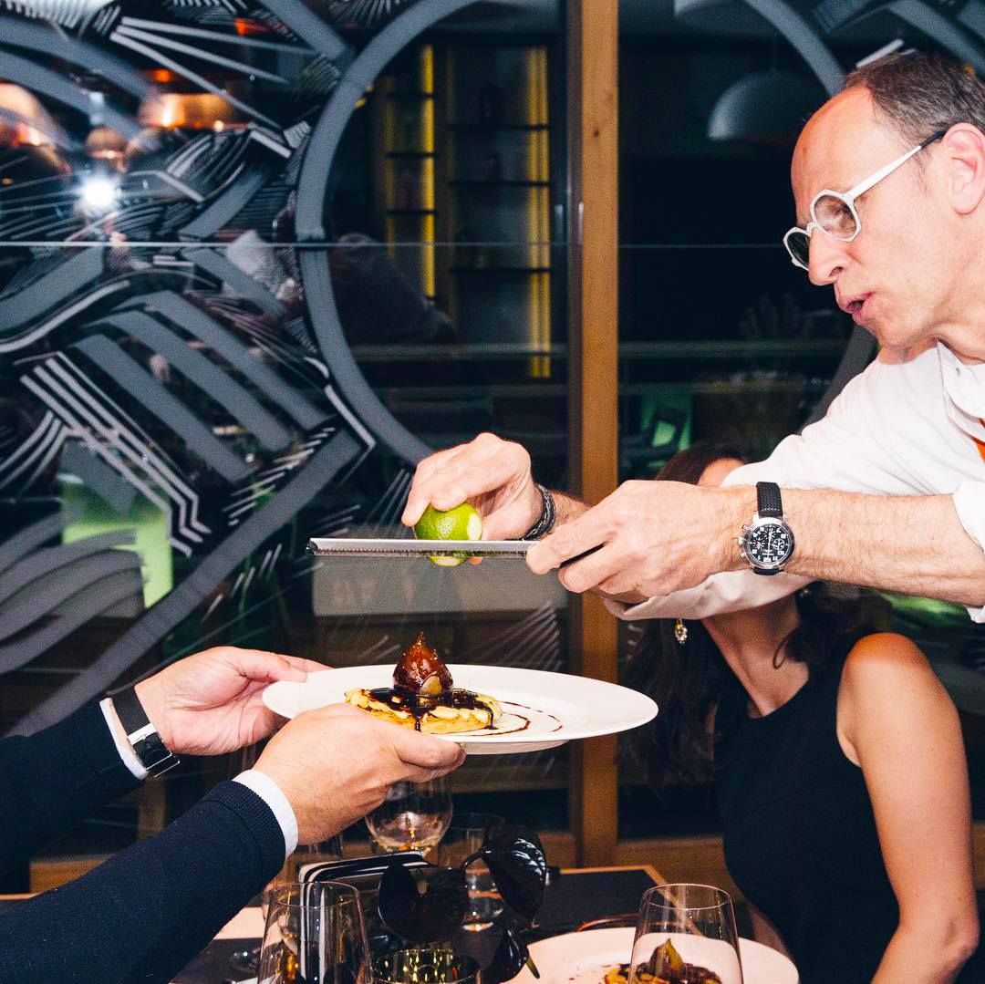 Michelin star chef Joel Cesari grating lime onto one of his signature dishes