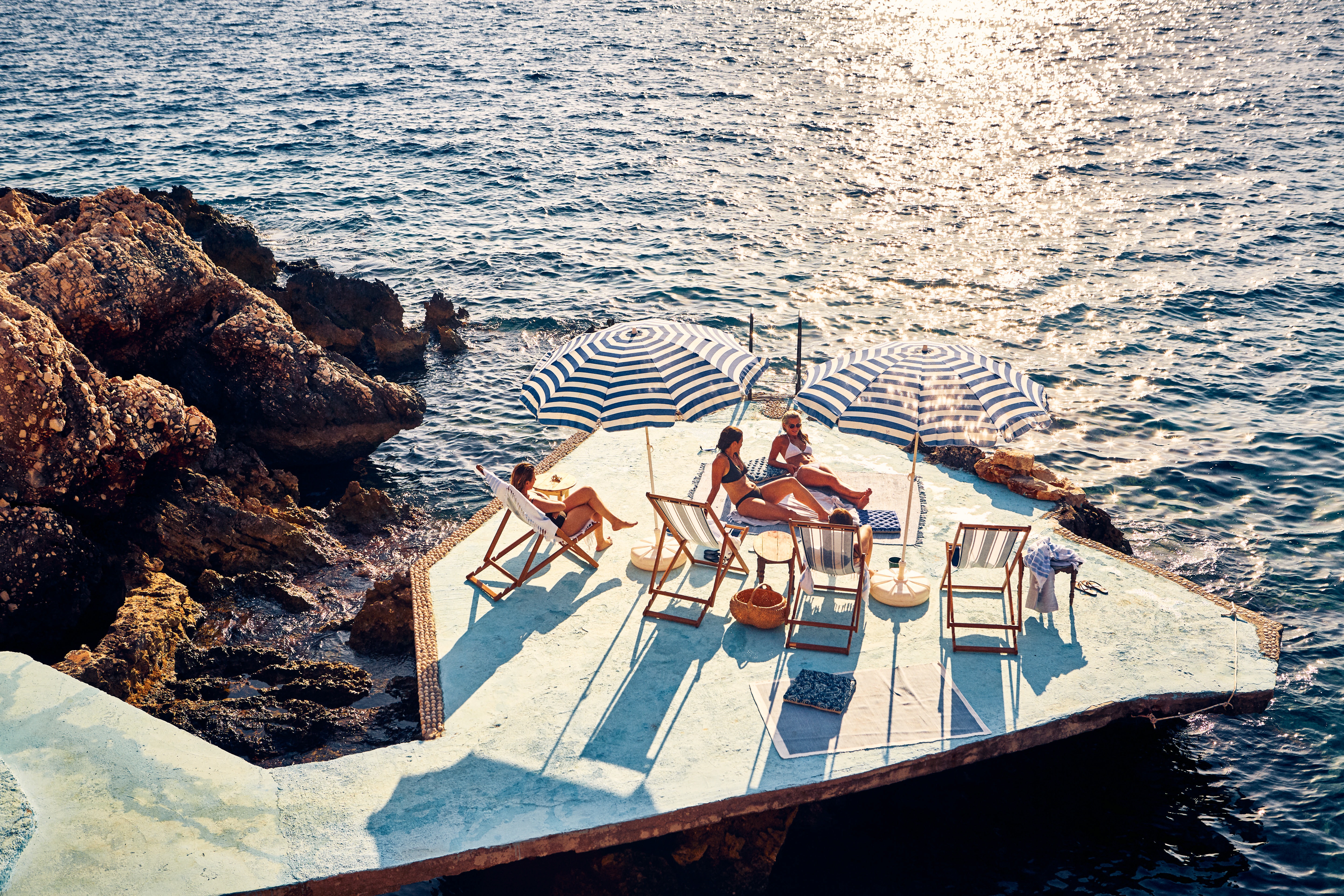 Relaxing blue hues on the pier of Canan and Leyla's family home mirror the refreshing palette of the coast