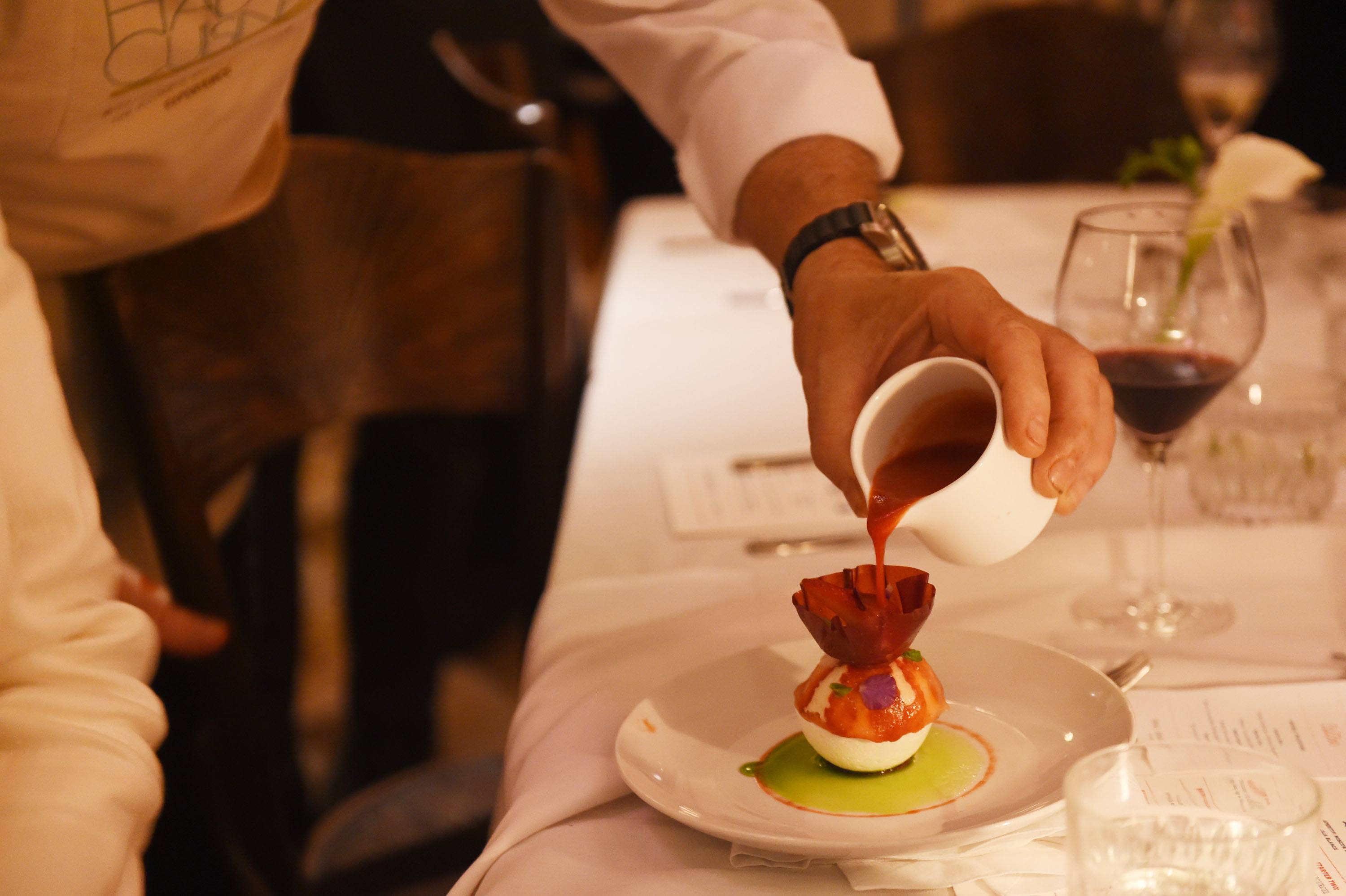 Haute Cuisine dessert featuring a strawberry sphere with lemon and basil