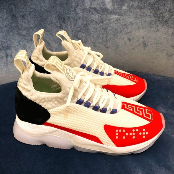 Versace Cross Chainer Sneaker in white featuring the chain link outsole and Greca details, while the puff croc neoprene accents and rubber-dipped laces add a street edge. Braille "Power" and "Versace" lettering gives a bold statement