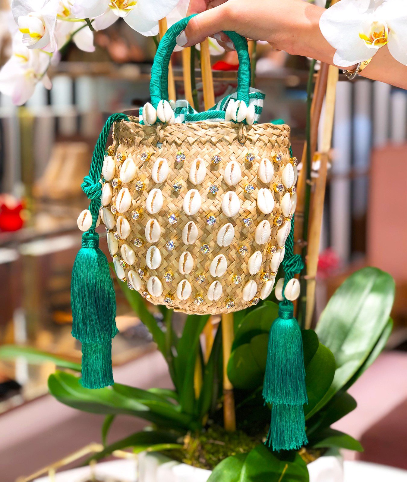 The Aquazzura Riviera bag is one of the styles created in collaboration with Le Ninè for the Escapes Capsule Collection. Hand-crafted from natural raffia, embellished with tropical cowrie shells, eye-catching crystals and swingy tassel