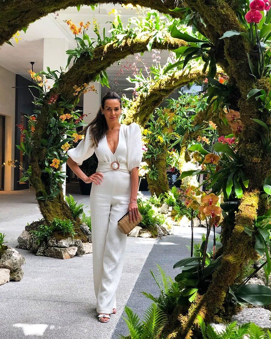 Brazilian model, television reporter, host and Bal Harbour Shops friend Carol Scaff inside one of the 8 circular floral 'Moongates' structures