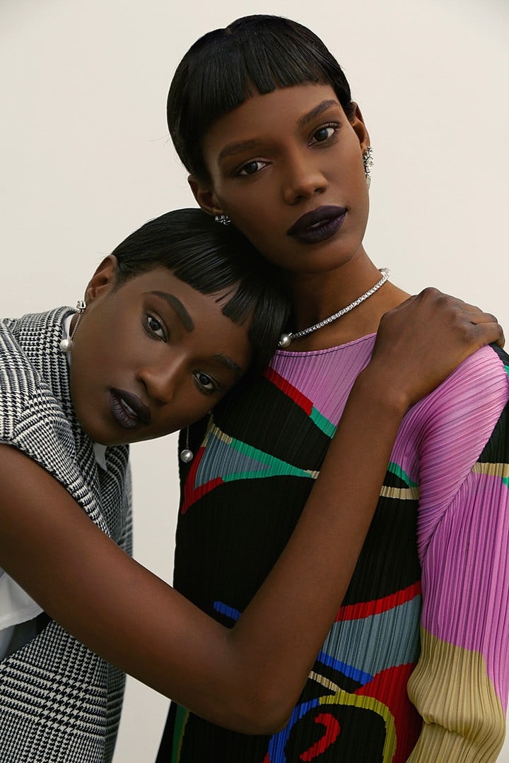 On Janica: Miu Miu black and white oversized houndstooth vest, solitaire earrings. On Eftagine: Issey Miyake pleated multicolor dress, available at Saks Fifth Avenue, Miu Miu solitaire necklace and earrings.