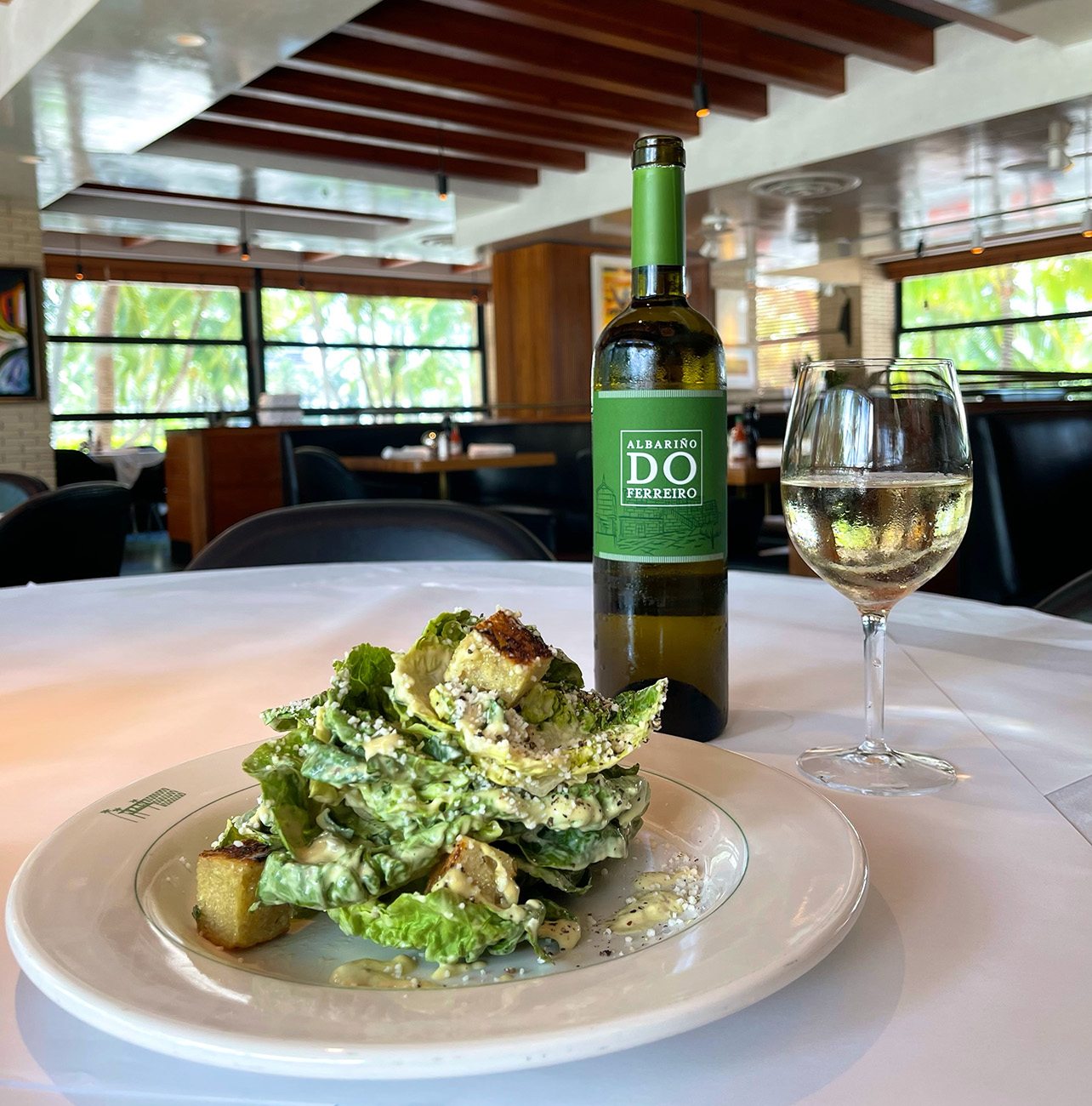 Hillstone Caesar salad paired with a glass of natural white wine