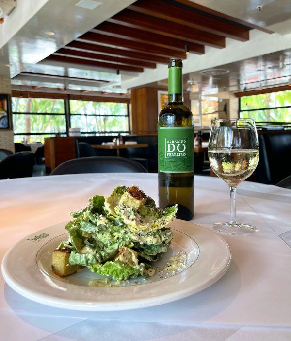 Hillstone Caesar salad paired with a glass of natural white wine