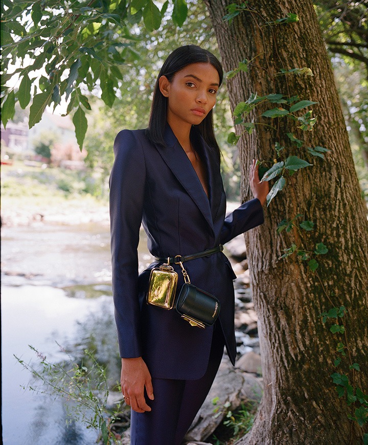 Alexander McQueen blazer, pants, Myth Cylinder clutch with attached harness and gold mini clutch.
