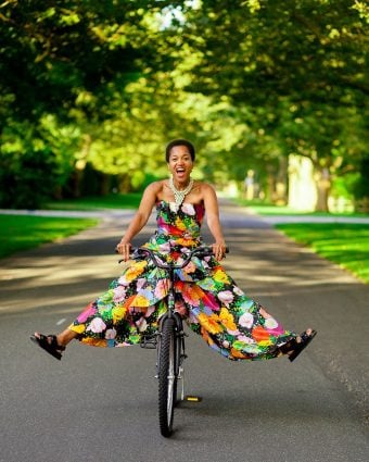 Tamu McPherson wearing a Richard Quinn dress, Chanel sandals and a cowrie shell necklace. Portrait by Myesha Evon Gardner.