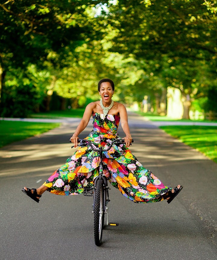 Tamu McPherson wearing a Richard Quinn dress, Chanel sandals and a cowrie shell necklace. Portrait by Myesha Evon Gardner.