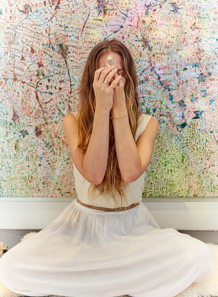 Benmeleh at home in front of a painting by Tomm El Saieh. Photo by Bernardo Gasparini.