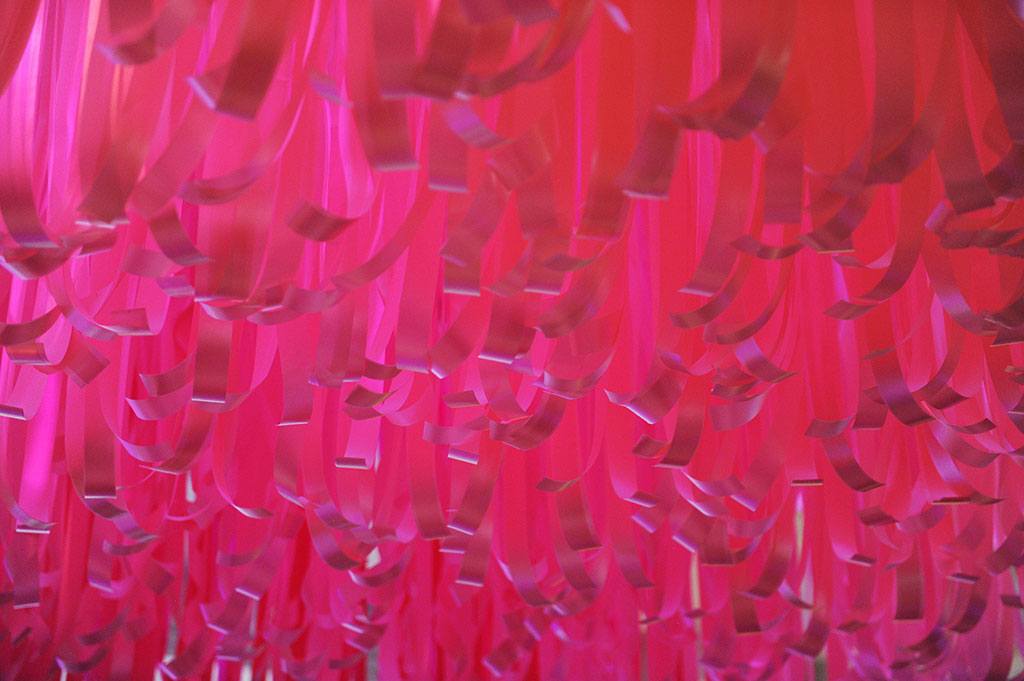 In honor of BCRF, an ombre of pink ribbons suspended over the supporters at the event. Photo by World Redeye