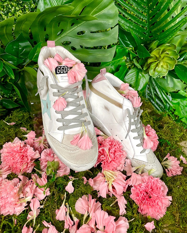 Golden Goose Mid Star sneakers with “Love is everything” lettering available at Golden Goose Bal Harbour.