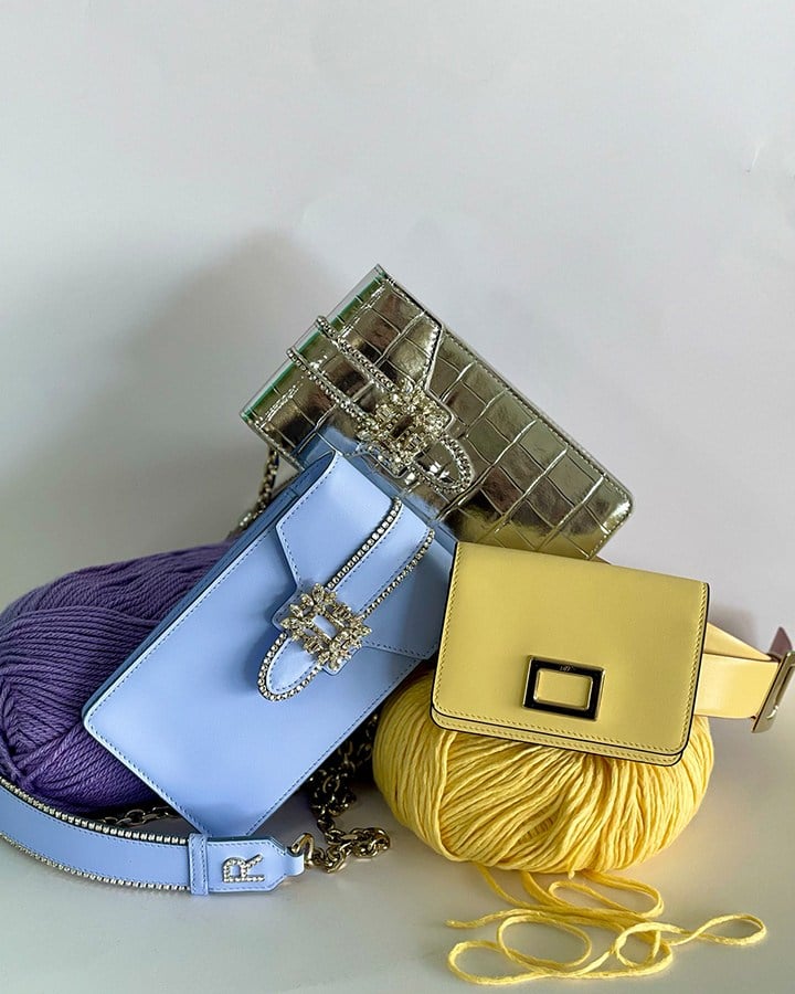 Roger Vivier’s Miss Vivier silver pocket phone holder with crystal-embellished buckle, Miss Vivier violet leather pocket phone holder with crystal-embellished buckle, and butter yellow leather belt bag.