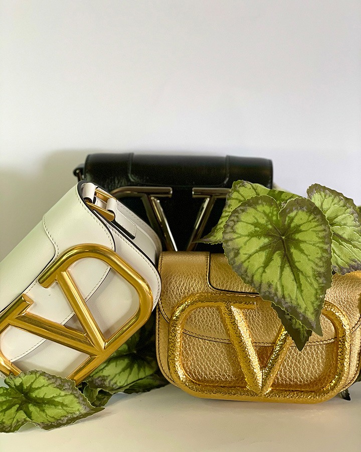 Small Valentino Garavani Supervee crossbody bags in calfskin leather with maxi VLogo Signature. Pictured in three colorways : Optic White, Black, and Gold.