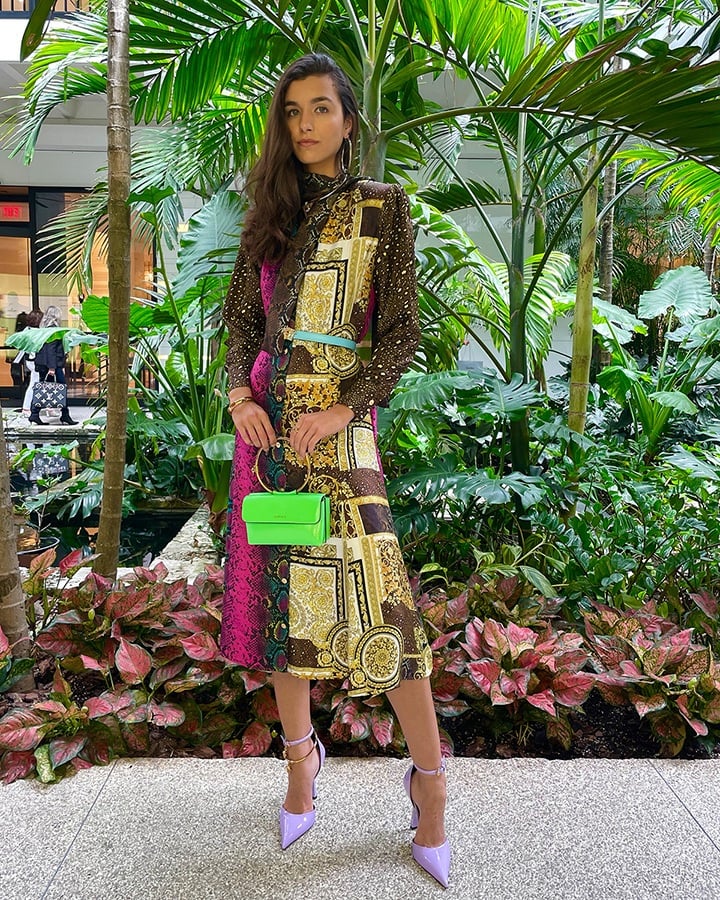 Versace Mixed print silk midi dress, blue Palazzo Dia crystal leather belt, green Medusa Aeternitas Naplak evening bag, thick gold bangle bracelet, gold Grecca hoop earrings and silver Medus Aeternitas choker necklace from the SS21 collection.