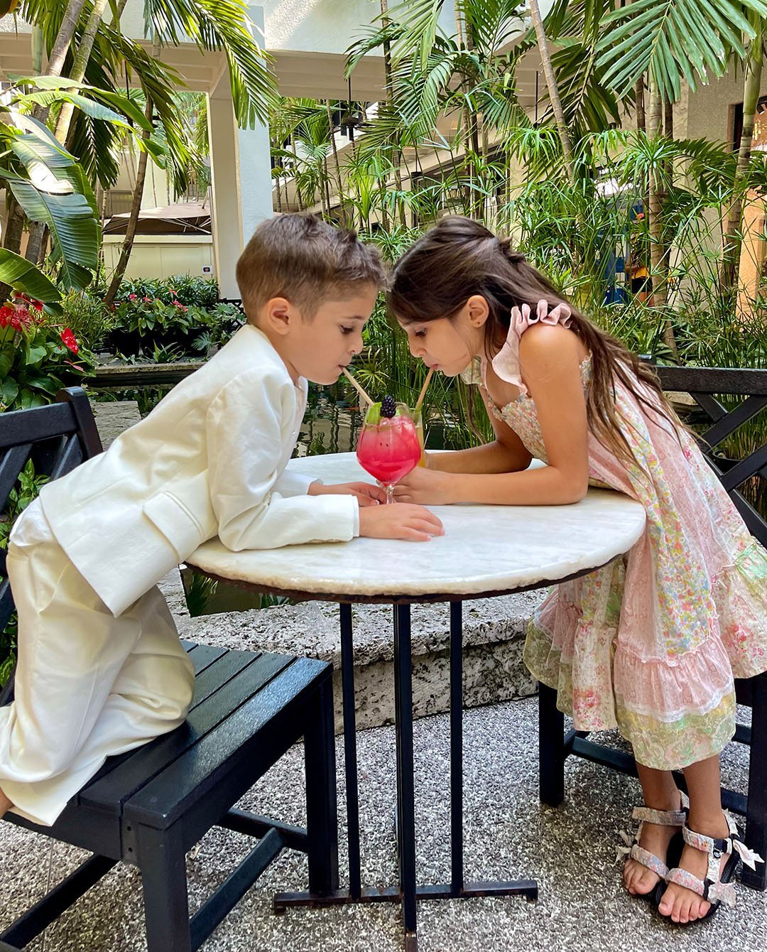 Pictured at Makoto, Bonpoint pink patchwork dress and multi-colored Liberty fabric sandals; and three-piece white linen suit and shirt.