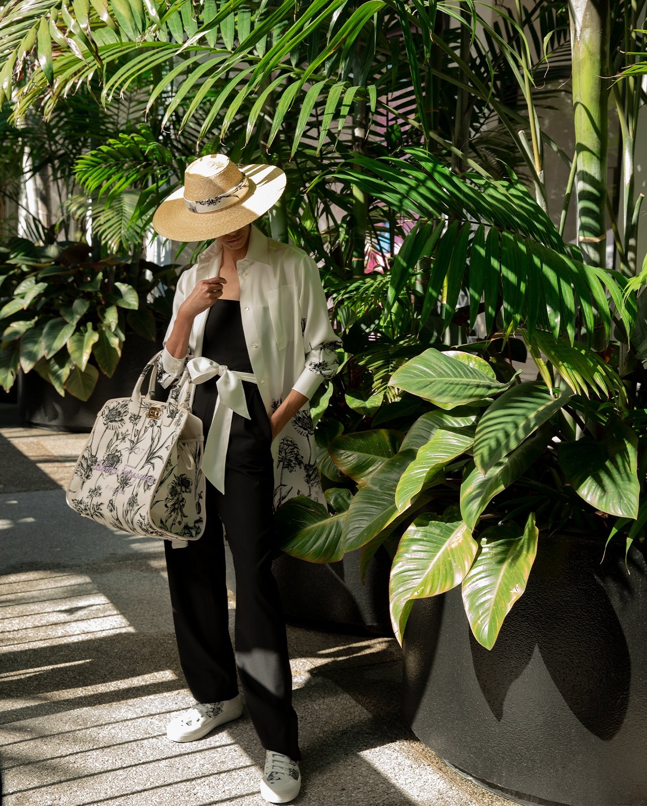 Salvatore Ferragamo black strapless jumpsuit, styled with silk kimono, hat, sneakers from the Tuscan Wildflower collection and the Miami handbag—a Bal Harbour Shops exclusive.