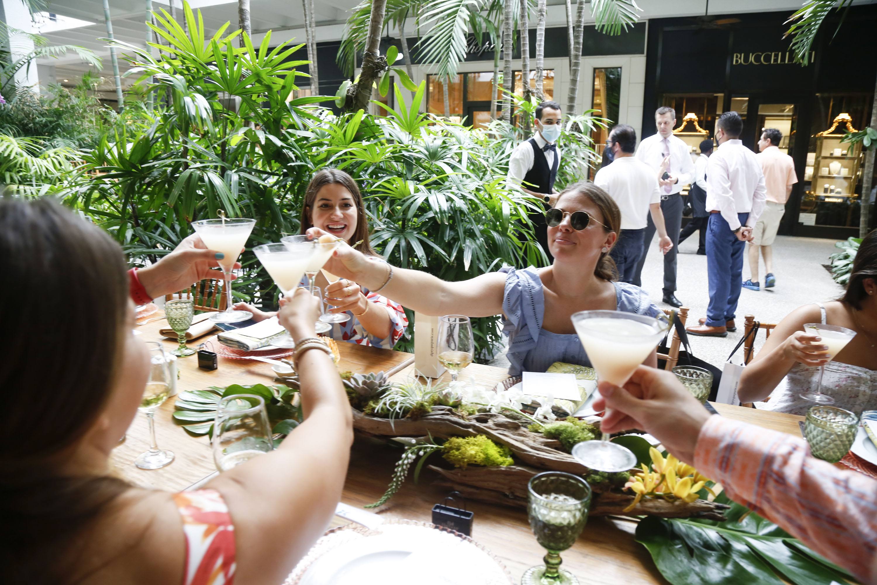 Event guests toasting with cocktails