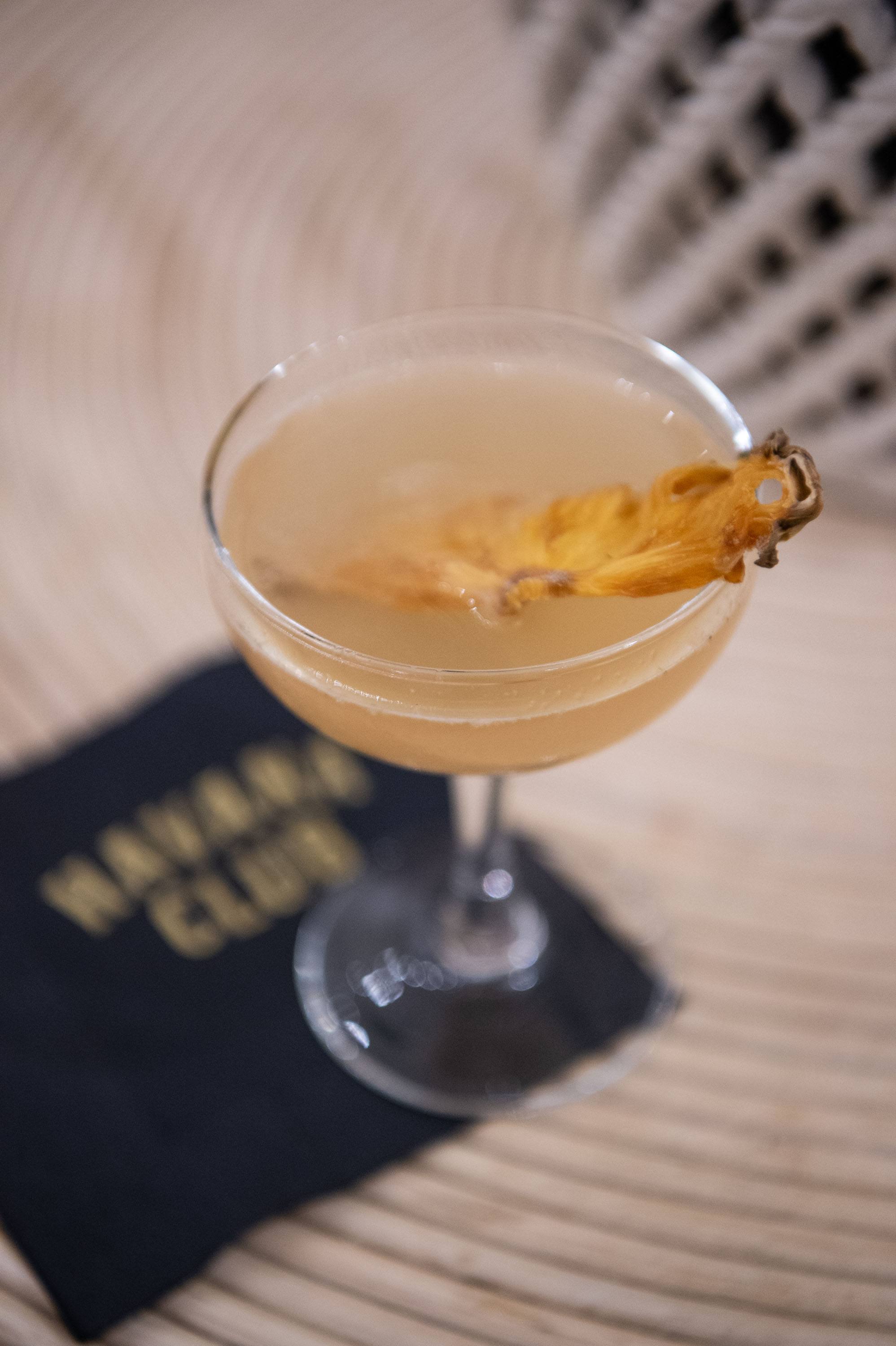 Rum cocktail with garnish photographed on a serving tray