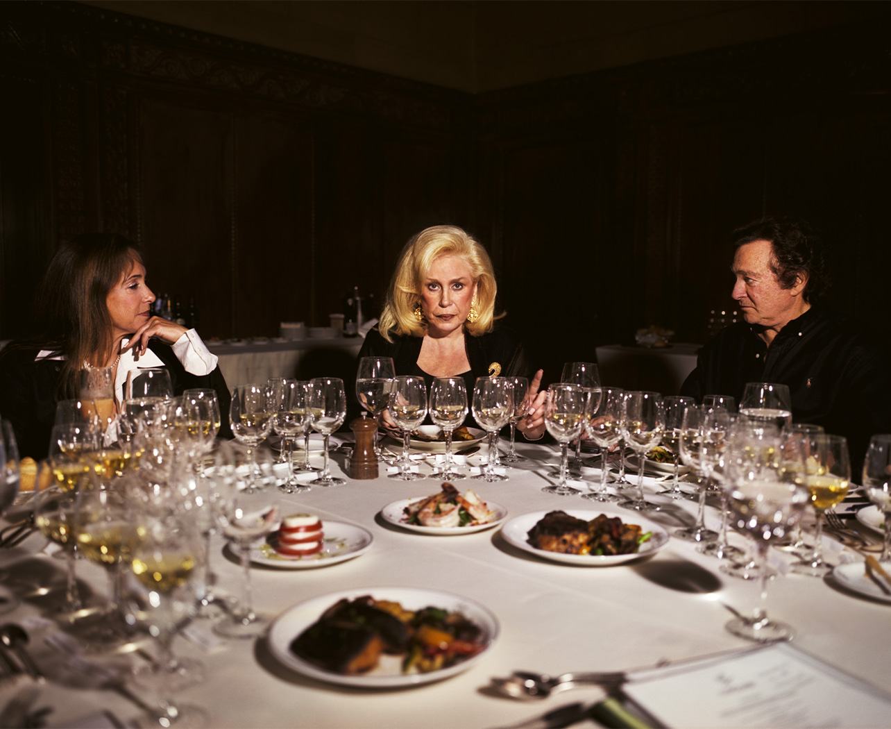 Photograph of three people sitting at a dining table
