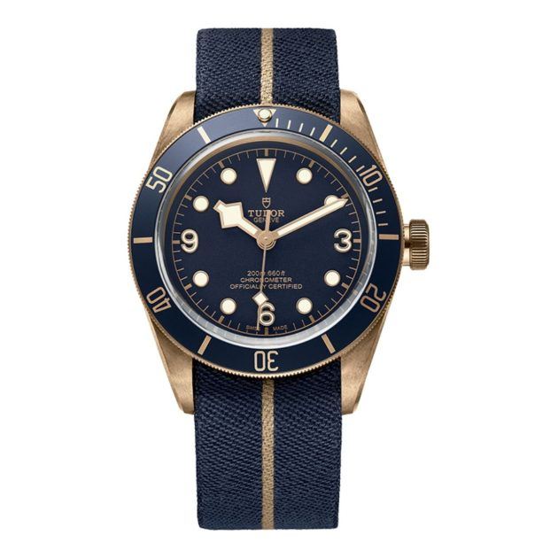 Tudor watch with a navy face, gold detailing and a navy woven wristband