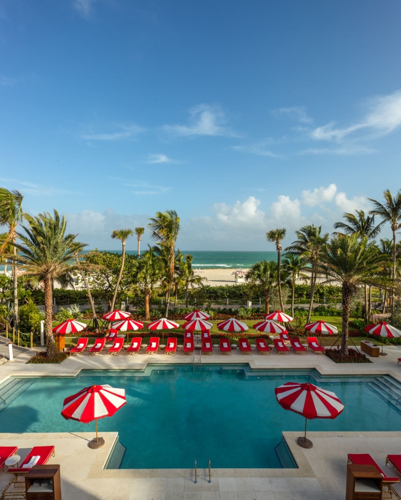 The Faena Hotel pool, decorated with red and white beach umbrellas