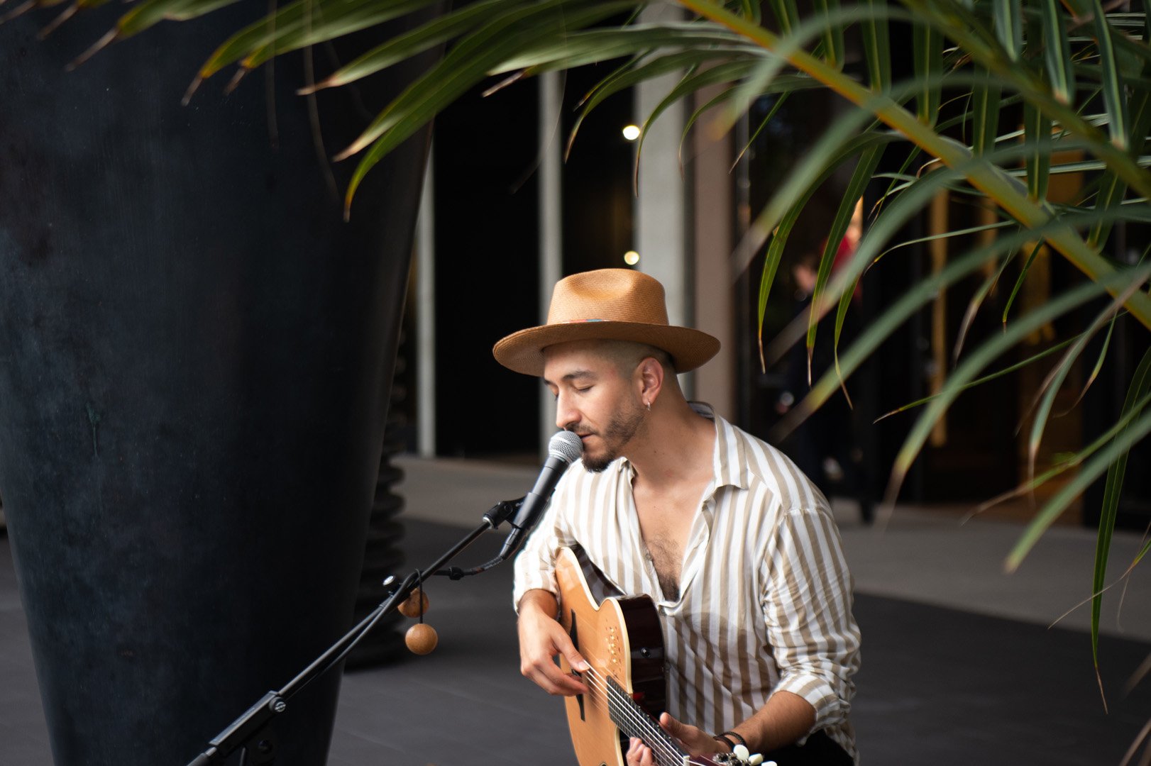 Andrade World photographed singing into a microphone