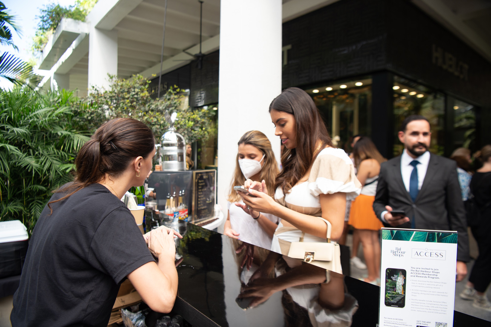 Two women speaking with a woman behind the Celebrity Cruises booth