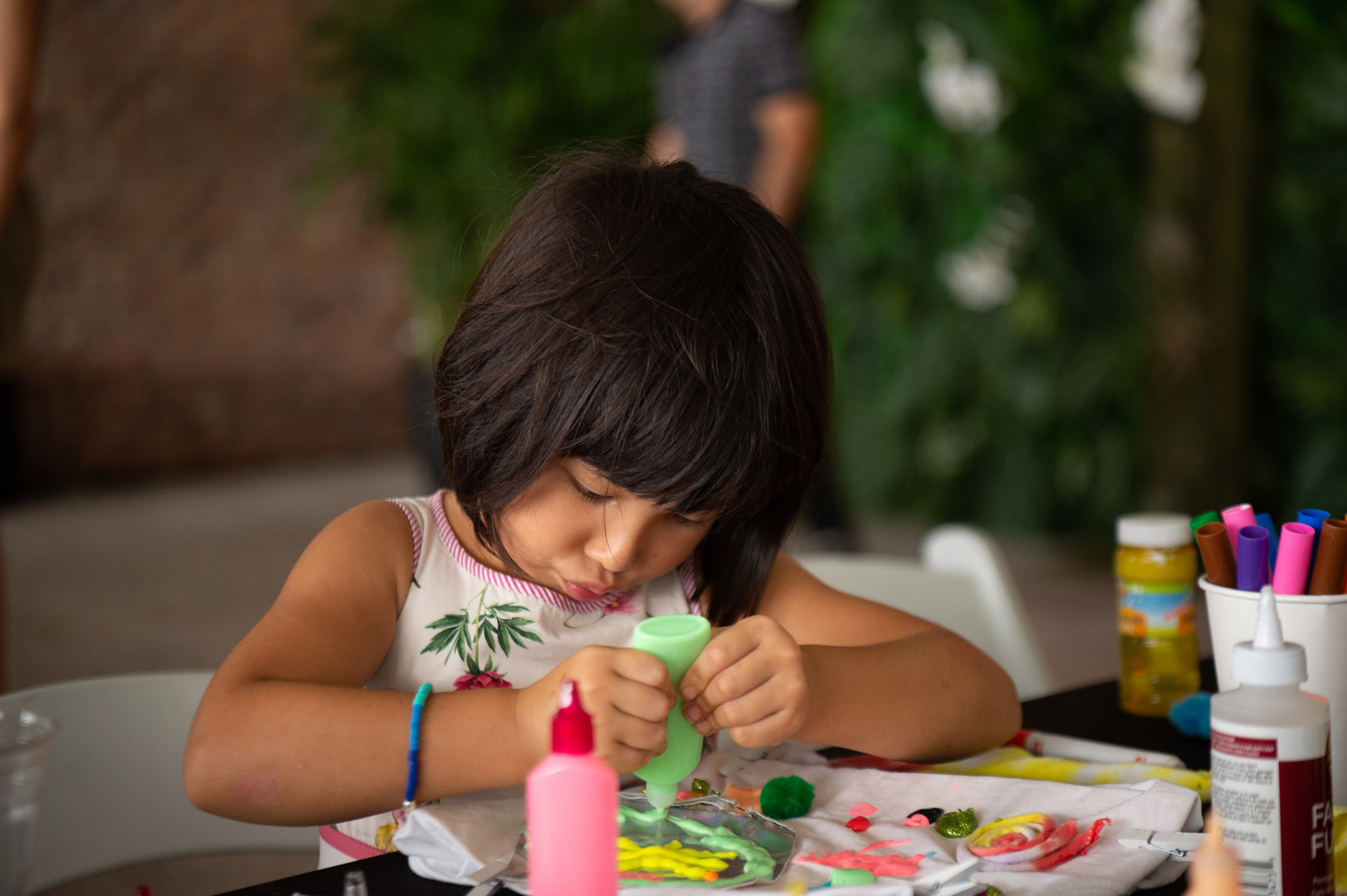 Little girl painting on a t-shirt