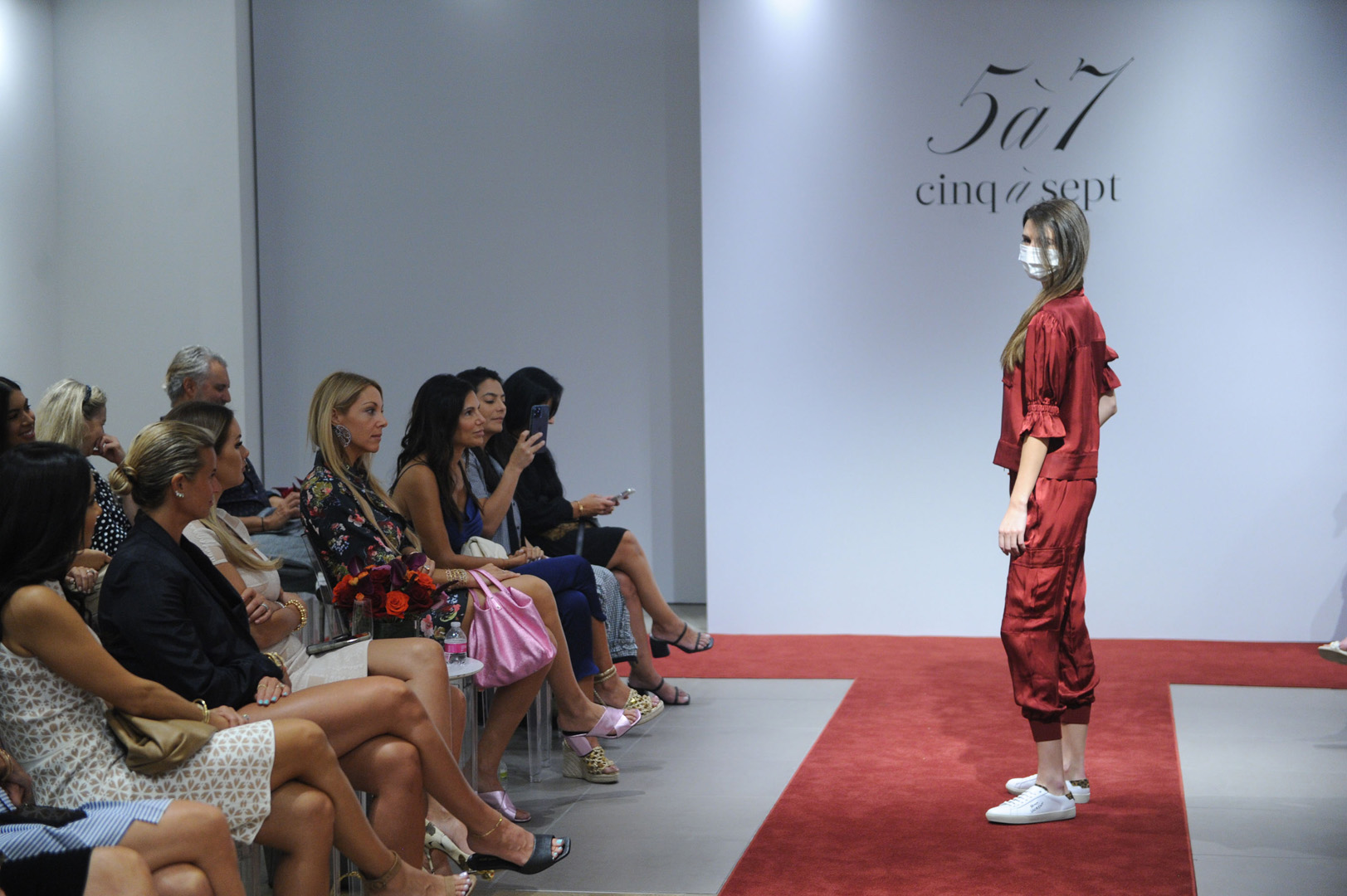 Model poses in a red silk set