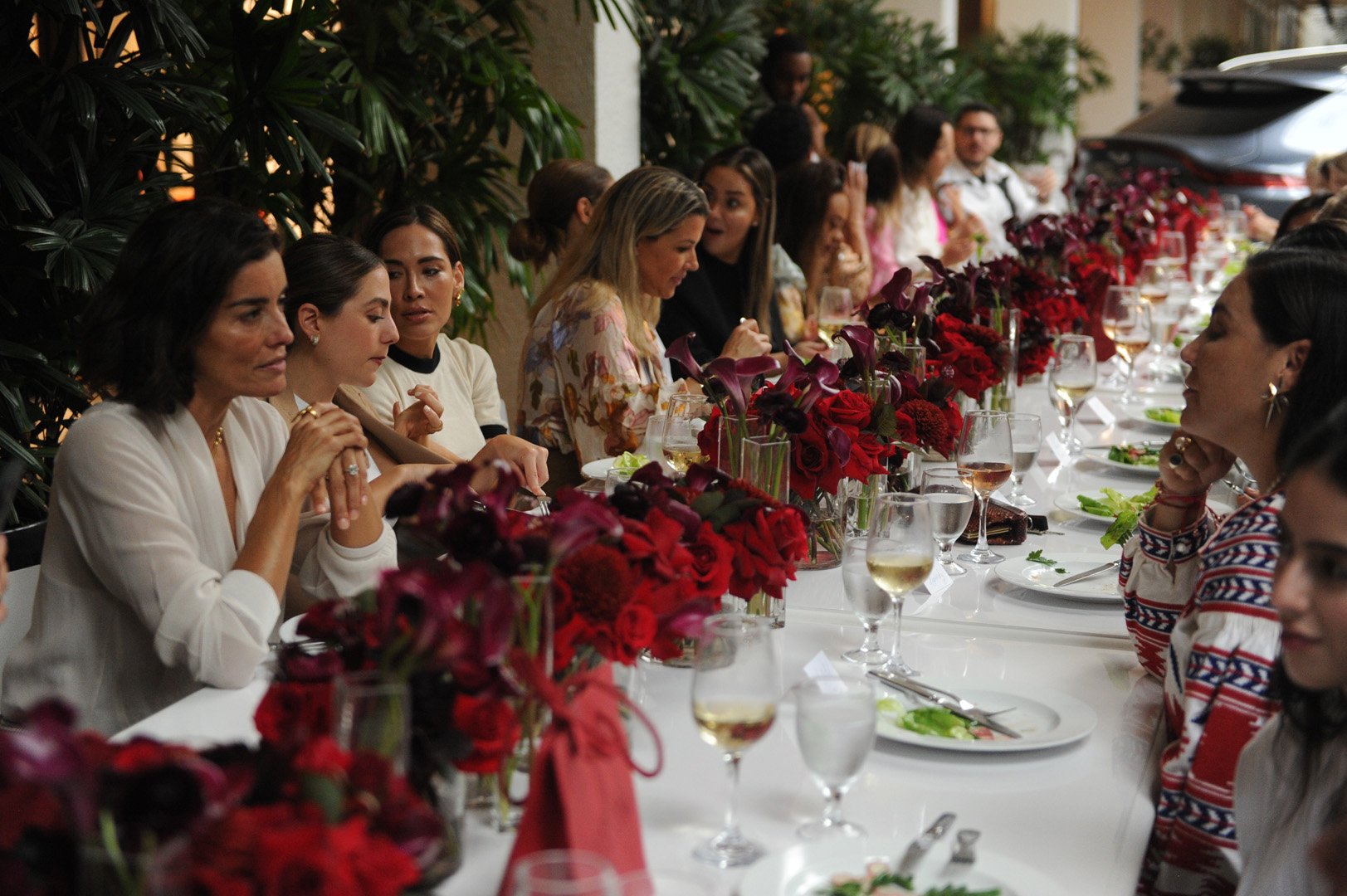 Table of woman photographed talking amongst each other