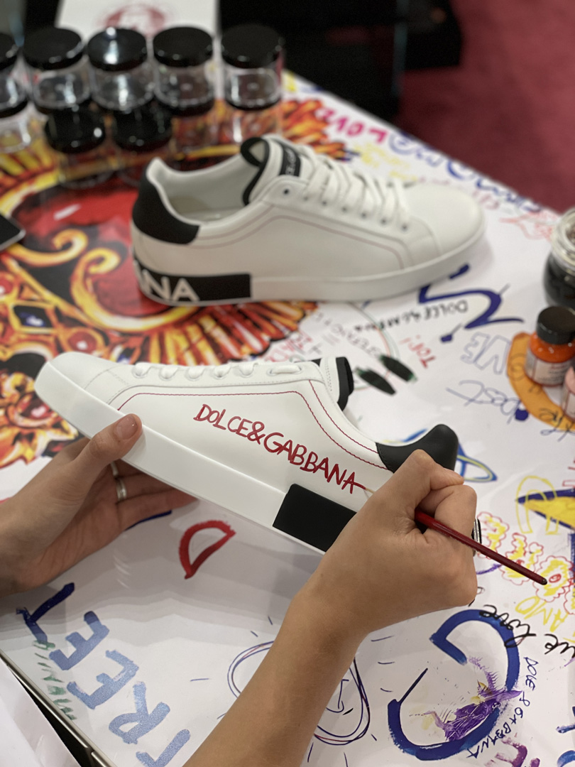 Woman paints a Dolce & Gabbana sneaker