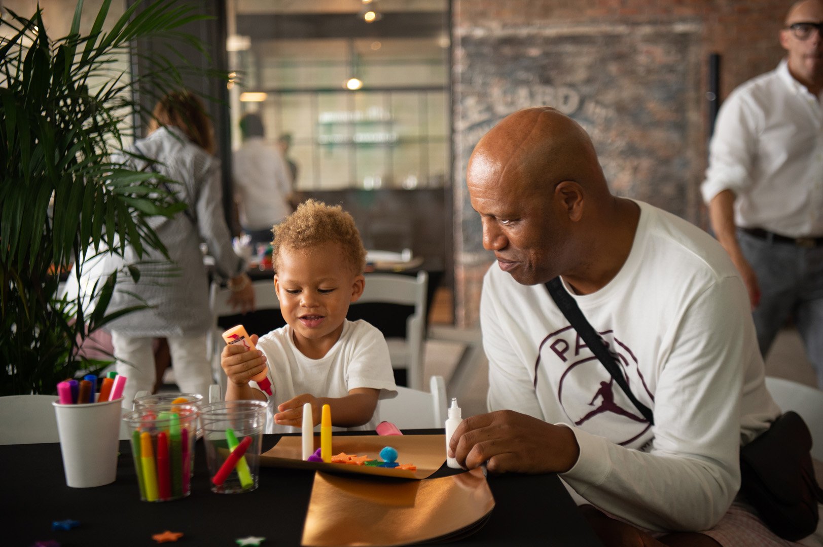 Tony Dortie and son Maximo play with arts and crafts supplies