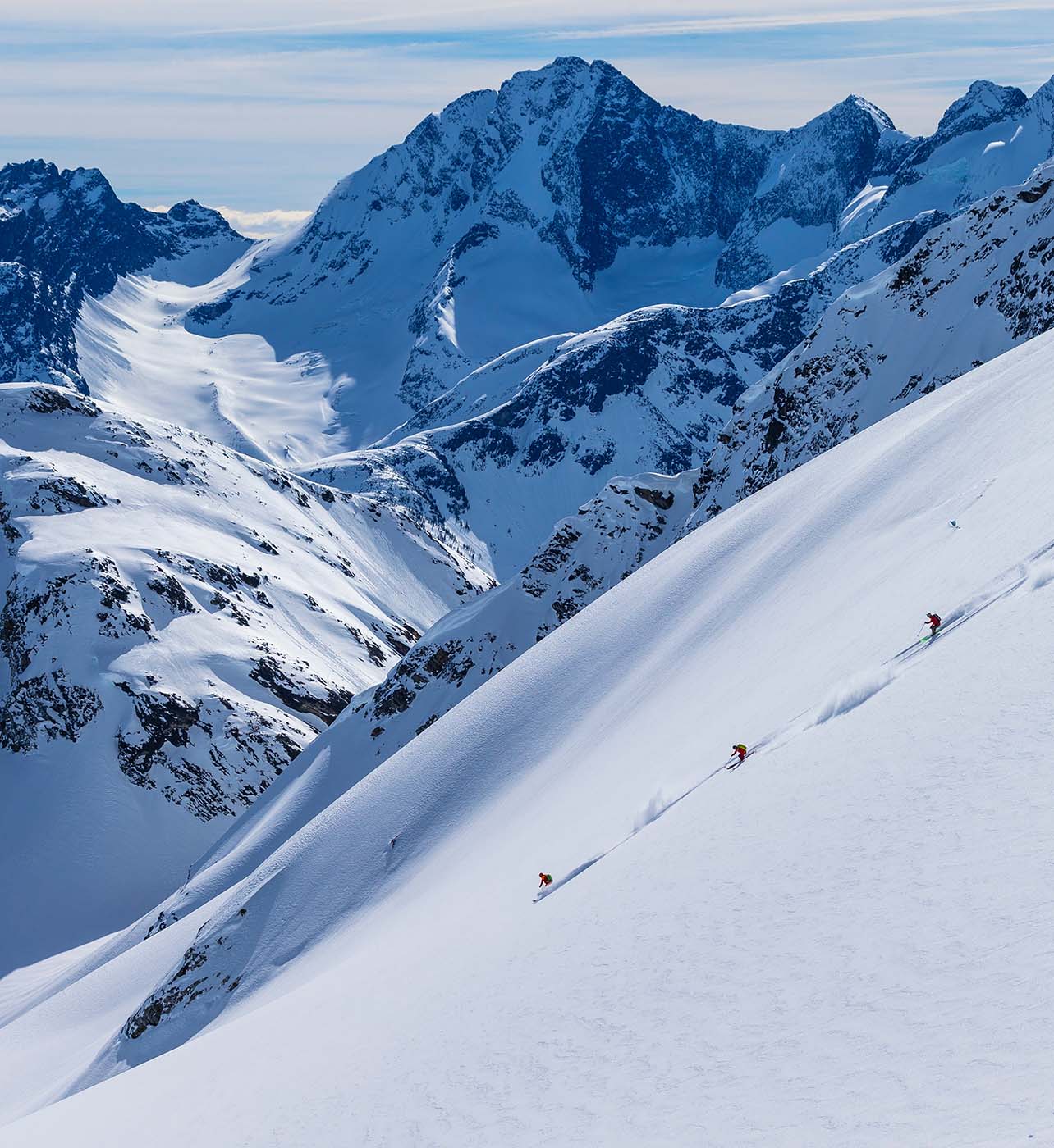 Skiers making their way down the mountainside in British Columbia
