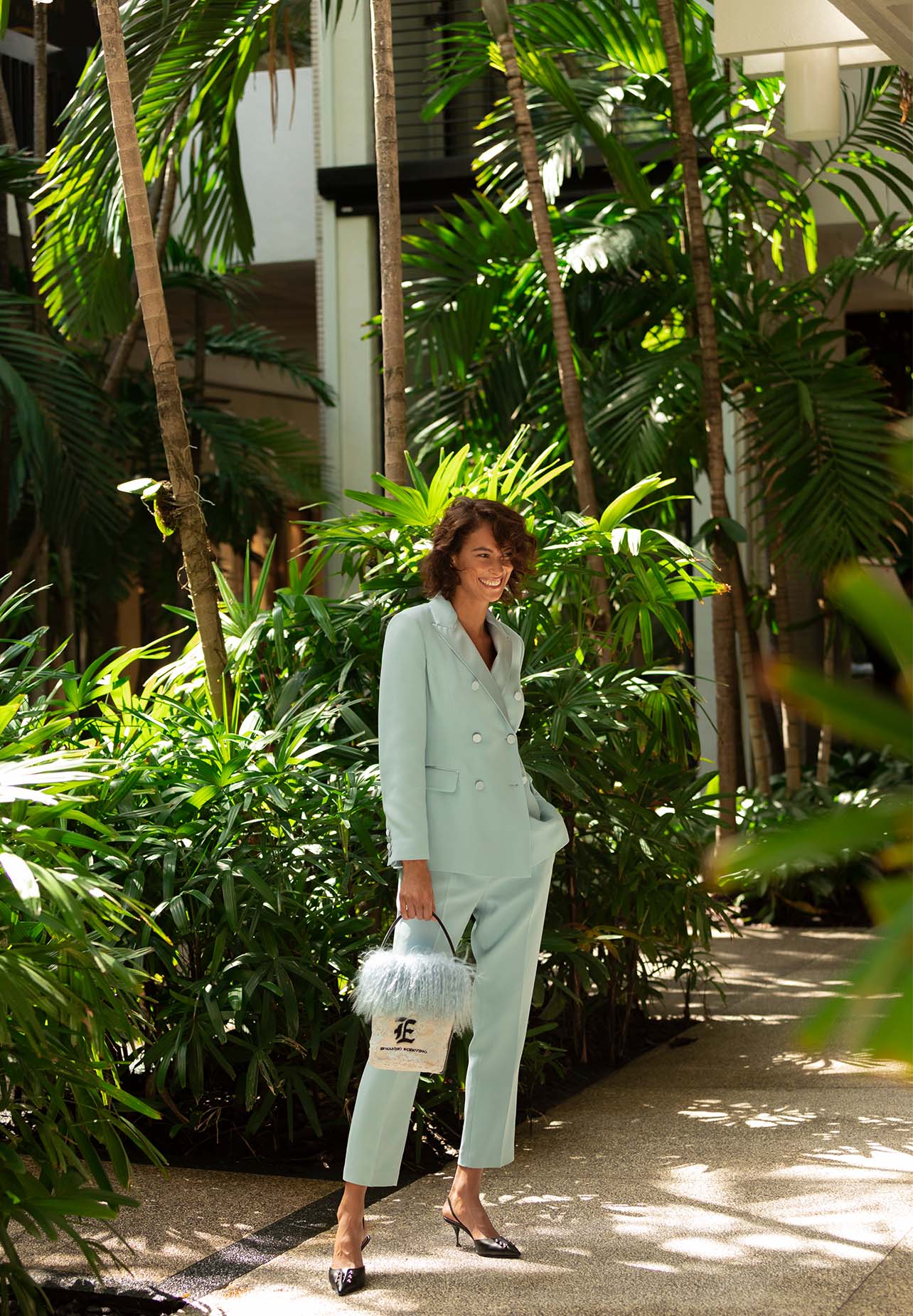 Model poses with a smile in a blue Ermanno Scervino suit