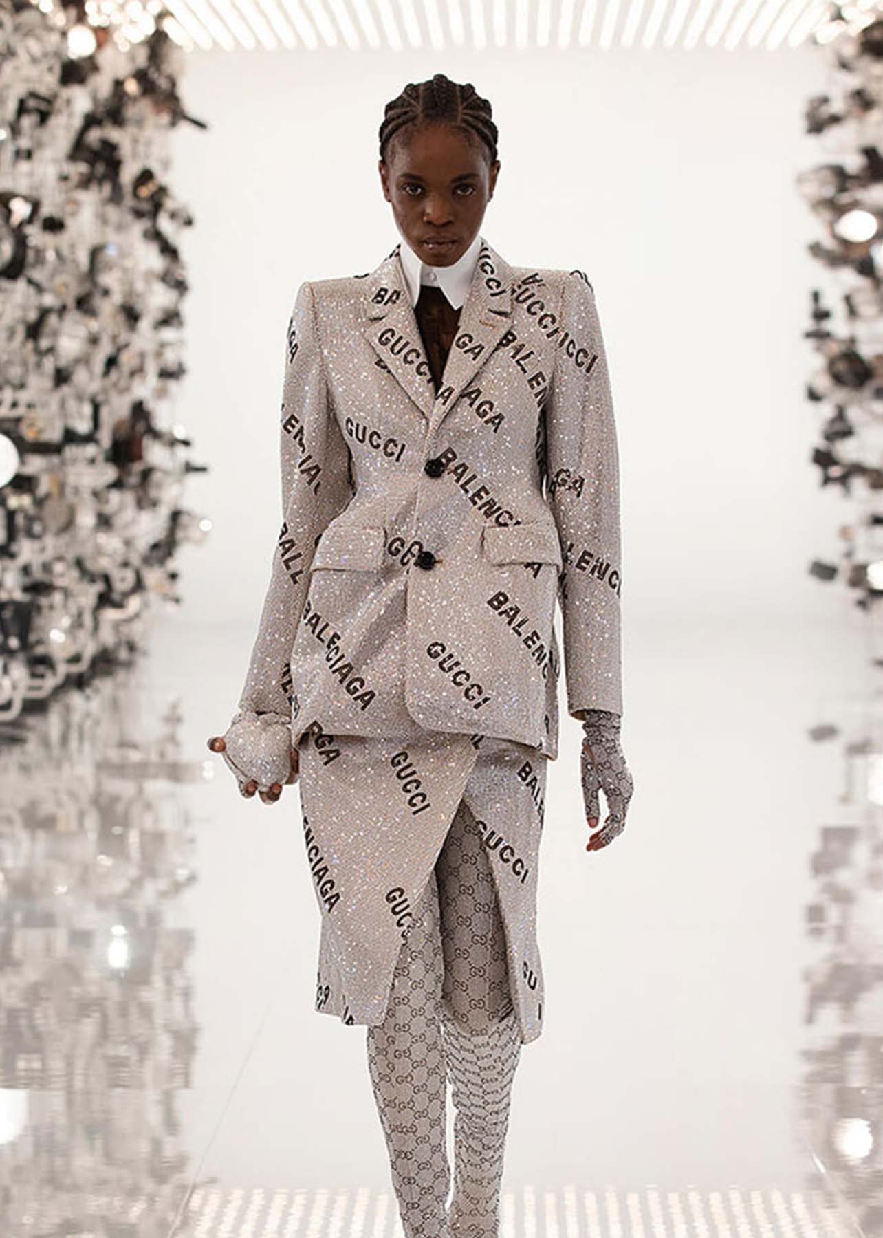 Metallic coat and skirt with Gucci and Balenciaga lettering across the clothing