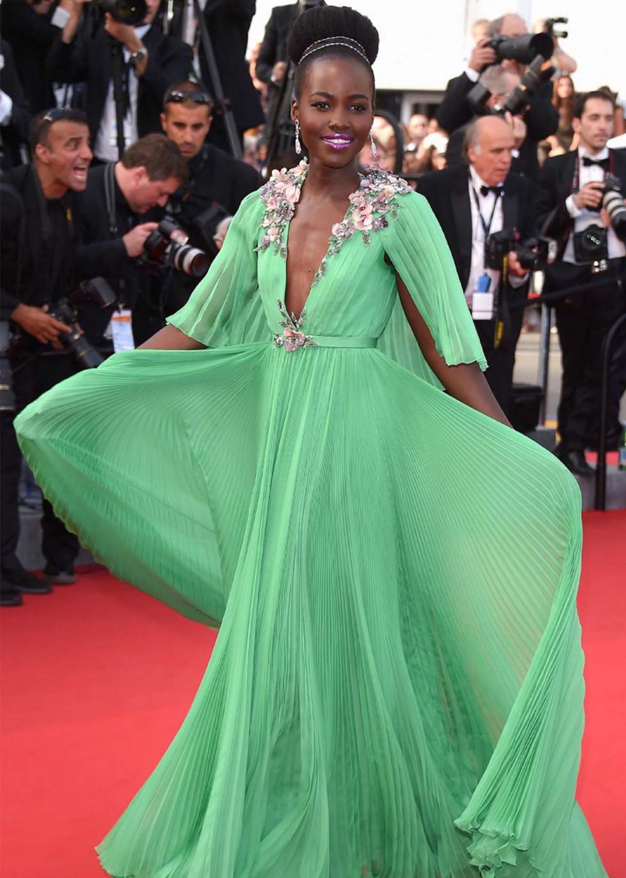 Lupita Nyong’o poses in a green gown