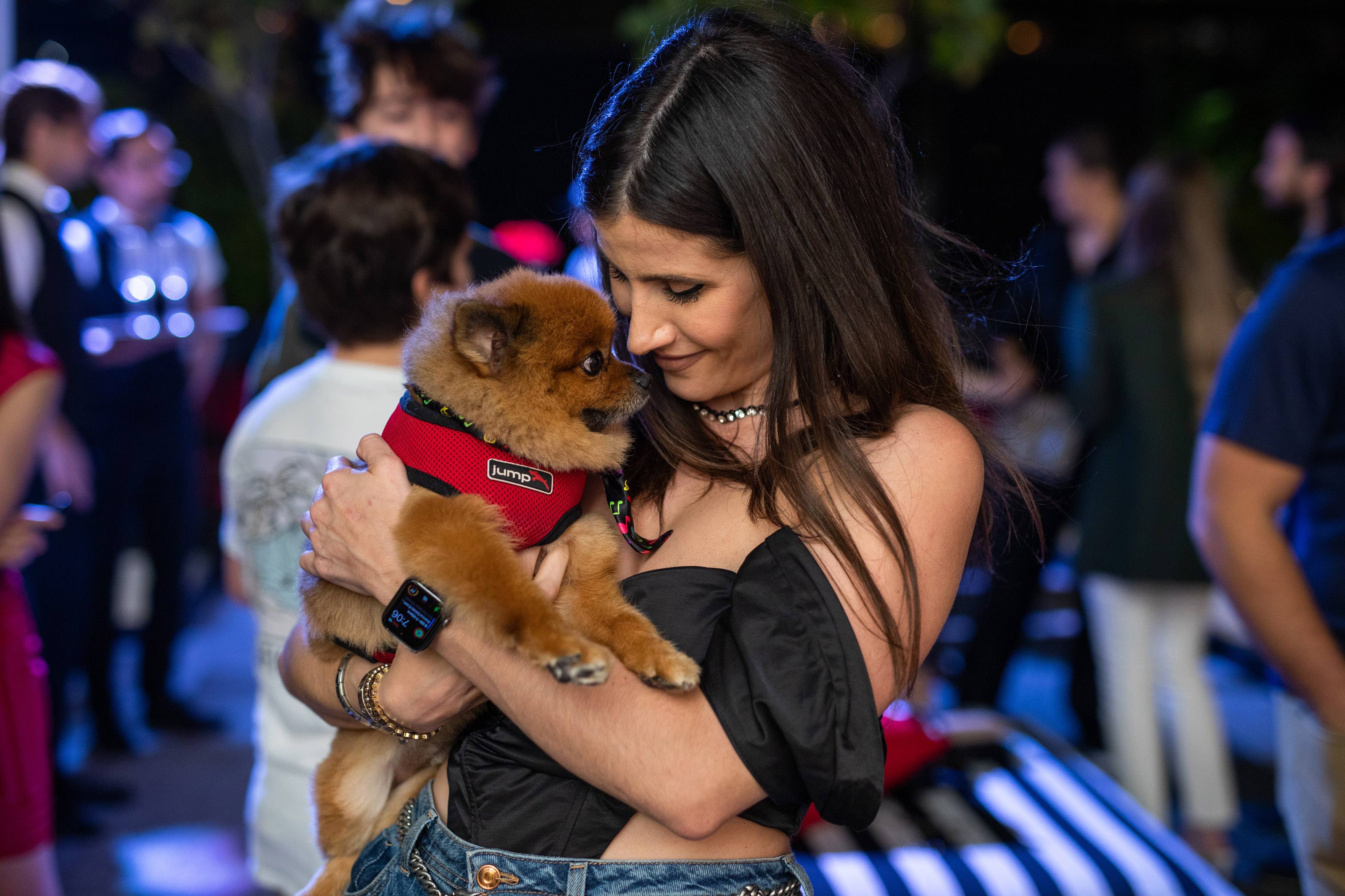 Woman smiles with a small dog